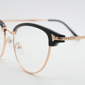 90s vintage browline cat eye glasses. Black gloss and gold half frame eyeglasses. 50s, 60s cateye design with clear lenses. NOS