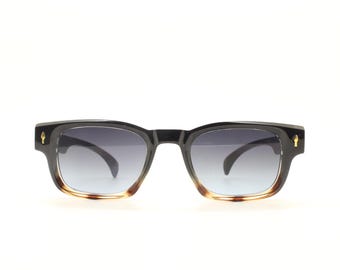 Vintage 90s low profile thick frame sunglasses. Black and tortoise ombre frame with graduating grey lenses. Unused NOS. One off sample