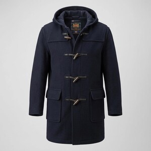 May include: A navy blue duffle coat featuring a hood, long sleeves, and two large front flap pockets. The coat closes with three wooden toggles and leather loops. A label inside the neck displays the text Gloverall and Made in England.