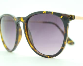 90s vintage sunglasses. Tortoise gloss frame with graduating black lenses and contrasting gold arms. Unused NOS