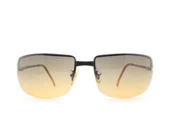 Y2K vintage curved rectangular sunglasses. Minimal half frame in brown chrome with grey to amber fade lenses. 2000's. 00's NOS