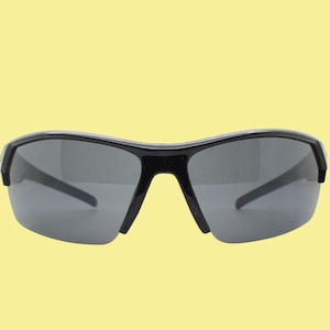 Y2K vintage sport shield sunglasses. All black wraparound aerodynamic visor with blue arm detail. 2000&#39;s. 90s. Unused NOS