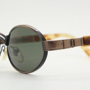 90s oval vintage metal and tortoise sunglasses. Quirky small size design with all the fashion features of their era. Unused NOS