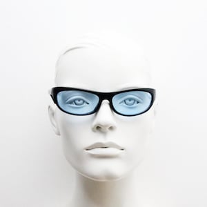90s vintage curved wraparound sunglasses. Aerodynamic low profile black satin finish frame with light tone blue lenses. Sports shield. NOS