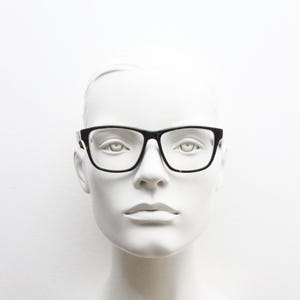 Cheap Monday rectangular low profile eye glasses. Dark brown tortoise gloss finish acetate optical frames. Prescription RX spectacles