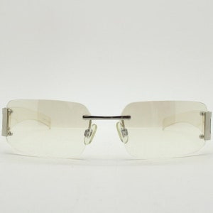 Y2K vintage wraparound sunglasses. Minimal frameless light tone curved mirrored lenses with silver chrome trim. 2000&#39;s. 90s. 00s. NOS