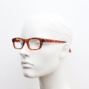 90s vintage rectangular low profile eye glasses. Transparent optical frame with vibrant amber giraffe pattern. Prescription eyeglasses. RX