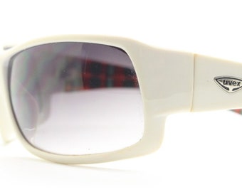 Uvex Y2k vintage wrap around bug eye sunglasses. Curving white sports shield frame with black lenses and tartan interior. Rave 2000s. NOS