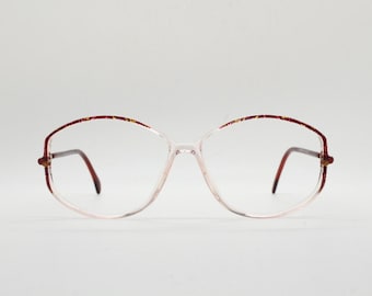 Gafas Silhouette hexagonales vintage de los años 80, fabricadas en Austria. Montura de cristal transparente con diseño abstracto rojo. Con receta médica.