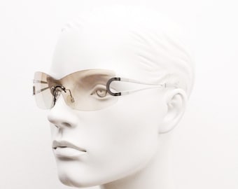 Y2K vintage visor sunglasses. 2000's brown wraparound mono lens shield design with looped chrome temples. 00s uber fashion mini mask NOS