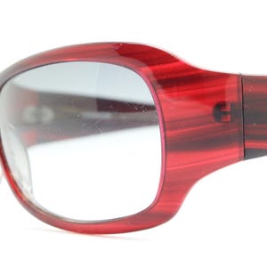 Y2k vintage wrap around large bug eye sunglasses. Curved red acetate shield frame with light tone lenses. 1960s bug eye design. 2000&#39;s NOS
