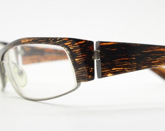 Alain Mikli 90s vintage eye glasses hand made in France. Low profile wrap around half frame in 'wood grain' acetate. Optical prescription RX