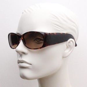 Y2k vintage wrap around bug eye sunglasses. Aerodynamic 60s design tortoise frame with full height arms in excellent proportions. 2000&#39;s NOS