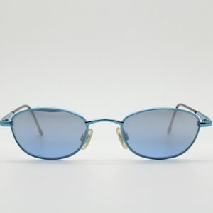 90s vintage small oval sunglasses by X-line. Unusual blue chrome metal frame with well matched mirror lenses. Quality NOS