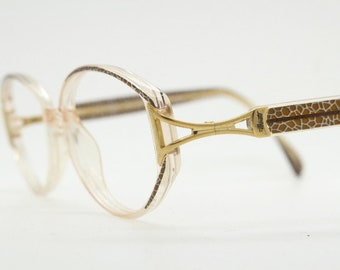 Silhouette 80s vintage oval eye glasses made in Austria. Transparent crystal optical frame with giraffe arm print. Prescription RX