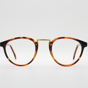 90s vintage round eye glasses. Minimal slim tortoise optical frames with gold bridge. 40s, 50s design prescription eyeglasses. RX spectacles