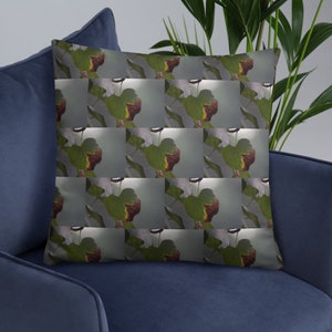 May include: A throw pillow with a repeating pattern of green leaves with brown edges on a light gray background.