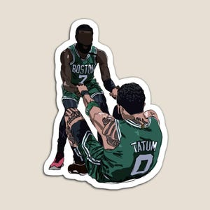 May include: A magnet featuring a stylized illustration of two basketball players in green and white uniforms. One player is helping the other up. The word "BOSTON" and the number "7" are visible on one jersey, and "TATUM 0" on the other.