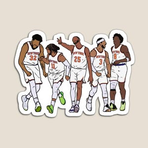 May include: A magnet featuring a stylized illustration of five basketball players in white and orange uniforms. Each player has a different jersey number. The text "NEW YORK" is visible on the jerseys. The players are in various poses, suggesting movement.