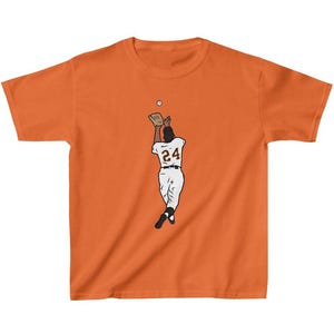 May include: Orange t-shirt with a cartoon illustration of a baseball player wearing a white uniform with the number 24 on the back, catching a ball.