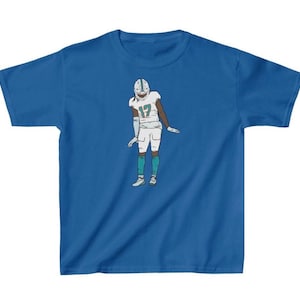 May include: A royal blue t-shirt with a cartoon illustration of a football player wearing a white jersey with the number 17 on it.