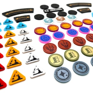 May include: A collection of colourful game pieces, including red, yellow, blue, white and black triangular tokens, as well as round tokens with various designs and colours. The tokens are arranged in rows on a white surface.