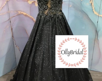 May include: A black sleeveless ball gown with a sheer bodice and floral lace detailing. The skirt is made of a sparkly fabric and has a flowing silhouette. The dress is displayed on a mannequin against a light blue and purple background. The image includes the text "OllyBridal".