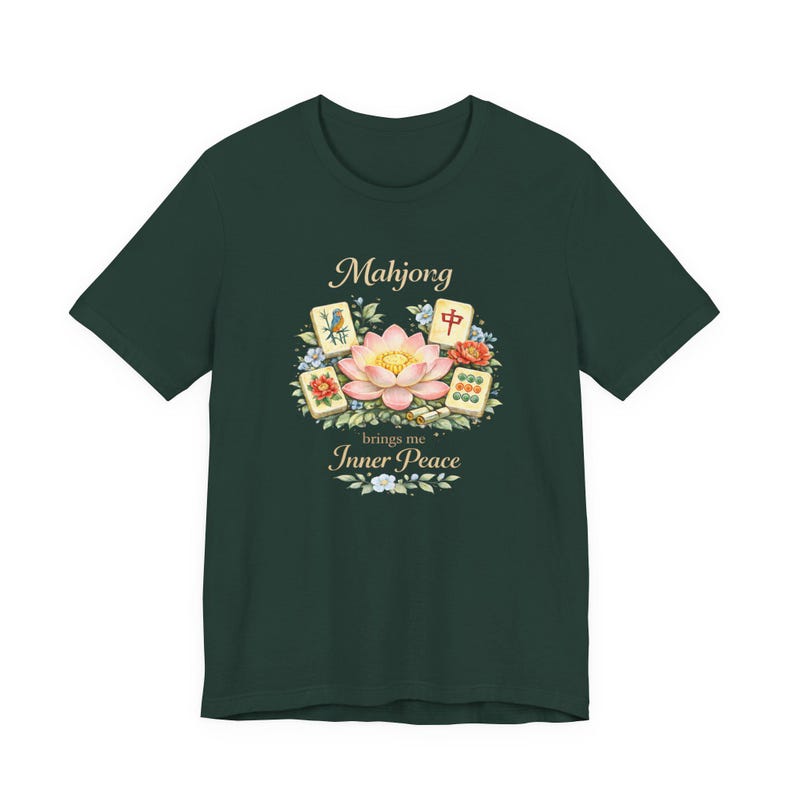 May include: Dark green t-shirt with a watercolour design. The design features the word "Mahjong" above a lotus flower and Mahjong tiles. The text "brings me Inner Peace" is below the flower, with floral accents.