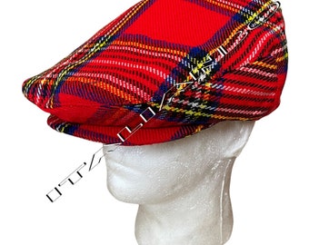 May include: A red, yellow, blue and white plaid newsboy cap. The cap is made of a soft, woven fabric.