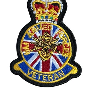 May include: Embroidered patch with a gold crown and a circular emblem. The emblem features a Union Jack design, a bee, and the words "ARMED FORCES VETERAN" in gold lettering on a black background.