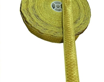 May include: A roll of gold trim with a zig-zag pattern. The trim is rolled up and tied with a white string.