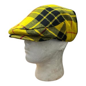 May include: A yellow and black checked newsboy cap with a red trim.