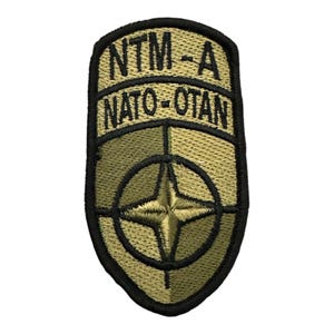 U.S. Army NATO Training Mission Afghanistan patch is an embroidered, iron-on badge