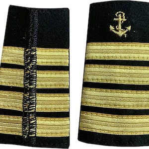 May include: A pair of black fabric epaulets with gold stripes and an embroidered anchor. The epaulets are used as a uniform accessory.