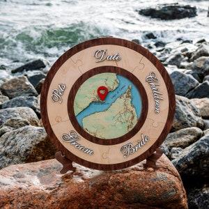May include: A wooden puzzle piece wedding guest book with a map of Lake Como, Italy. The puzzle pieces are labeled "Date", "Pets", "Groom", "Bride", and "Children".