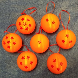 May include: Seven orange Christmas ornaments with red stars. The ornaments are round and have a shiny finish.