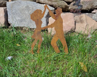 Sporty dancing couple made of rust as garden or flowerpot decoration