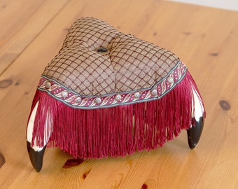 Elegant chocolate colored monster stool with faux horn legs and fringe, unique decor item