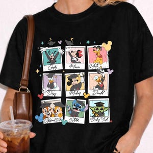 May include: Black t-shirt featuring nine framed images of Disney characters, including Goofy, Minnie, Pluto, Daisy, Mickey, Donald, Chip and Dale, Stitch, and Baby Yoda. The characters are wearing graduation caps. The shirt is worn by a person.