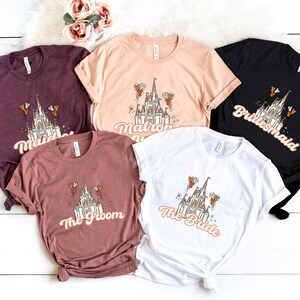 May include: Five t-shirts with a white castle graphic and text that reads "Maid of Honor", "Matron of Honor", "Bride", "The Groom", and "Bridesmaid".