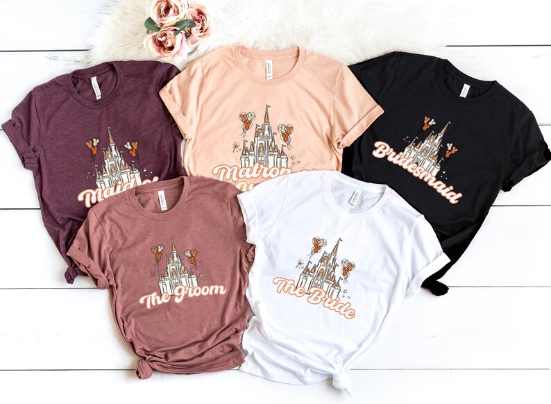 May include: Five t-shirts with a white castle graphic and text that reads "Maid of Honor", "Matron of Honor", "Bride", "The Groom", and "Bridesmaid".