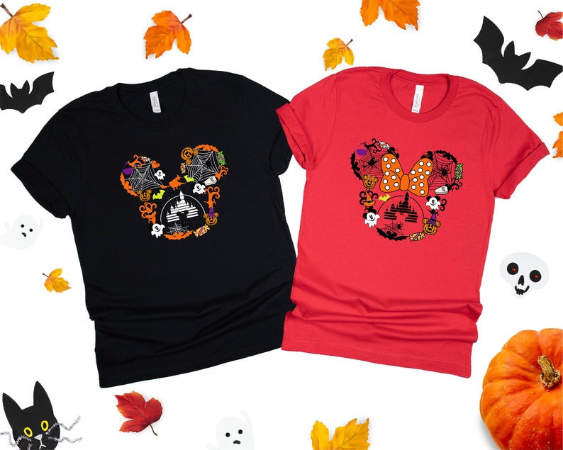 May include: Two black and red t-shirts with a Halloween-themed Mickey Mouse and Minnie Mouse design. The Mickey Mouse design features a black silhouette of Mickey's head with a castle, bats, pumpkins, and spiderwebs. The Minnie Mouse design features a red bow with white polka dots and a castle, bats, pumpkins, and spiderwebs.