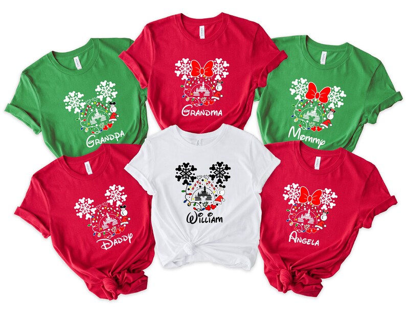 May include: Six red and green t-shirts with a white Mickey Mouse head design featuring a Christmas tree, lights, and ornaments. The shirts have the words "Grandma", "Grandpa", "Mommy", "Daddy", "William", and "Angela" printed on them.