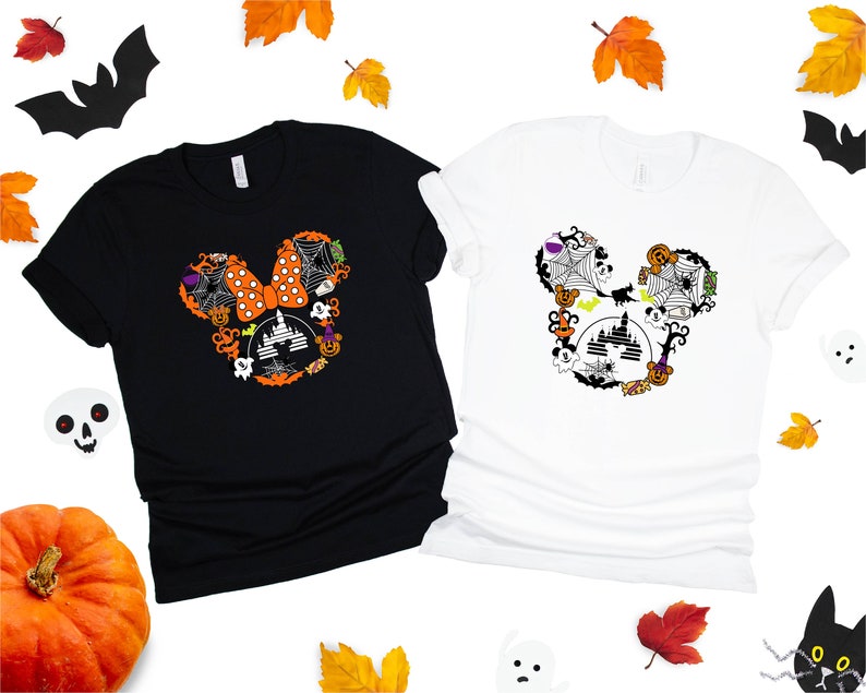 May include: Two t-shirts with a Halloween Mickey Mouse design. The black t-shirt has an orange and black Mickey Mouse head with a bow and the white t-shirt has a black and white Mickey Mouse head with a bow.