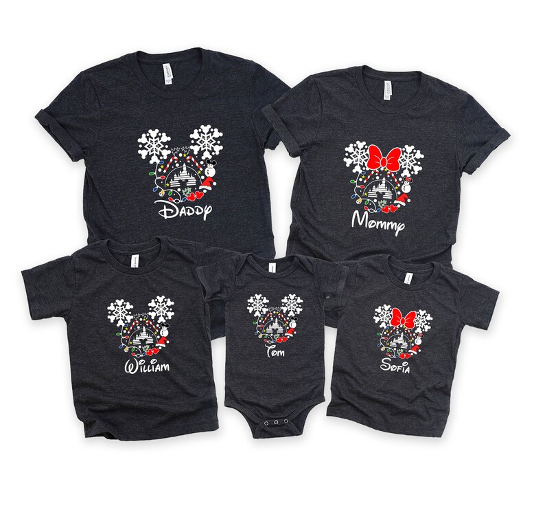 May include: A set of five gray t-shirts featuring a Mickey Mouse silhouette with Christmas lights, ornaments, and snowflakes. The shirts are personalized with the names "Daddy", "Mommy", "William", "Tom", and "Sofia".