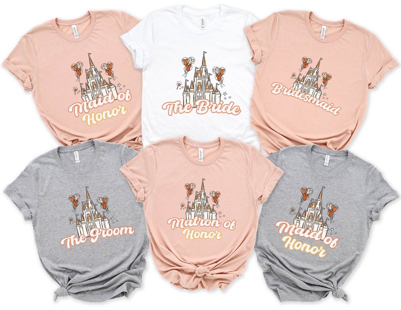 May include: Six t-shirts with a castle graphic and text. The shirts are in various colors, including pink, white, and gray. The text on the shirts includes "Maid of Honor", "The Bride", "Bridesmaid", "The Groom", "Matron of Honor", and "Maid of Honor".