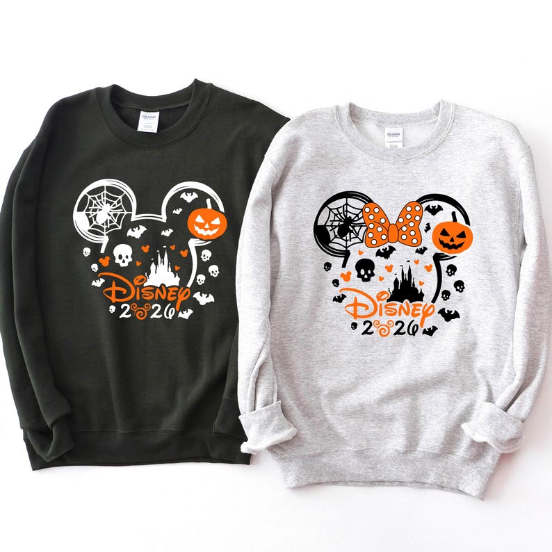 May include: A black sweatshirt and a light gray sweatshirt, each featuring a graphic of a Mickey Mouse silhouette filled with Halloween icons including a spider web, a jack-o'-lantern, a skull, bats, and the text Disney 2020 in orange.
