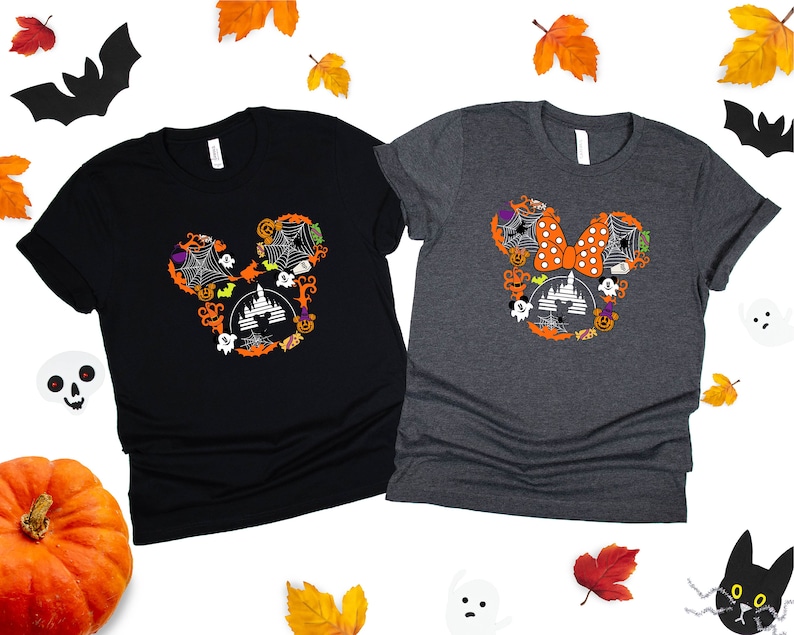 May include: Two black and gray t-shirts with a Halloween Mickey Mouse and Minnie Mouse design. The Mickey Mouse design features a black and orange castle with bats, ghosts, and pumpkins. The Minnie Mouse design features a red and white polka dot bow with bats, ghosts, and pumpkins.