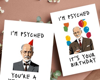May include: Two birthday cards featuring a cartoon illustration of Sigmund Freud. The first card says "I'm psyched you're a year older". The second card says "I'm psyched it's your birthday".