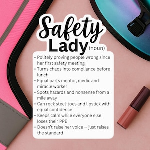 May include: A pink and black safety vest with the words "Safety Lady" and a list of qualities. A tube of lipstick is on the right side of the image. The background is a light pink color.